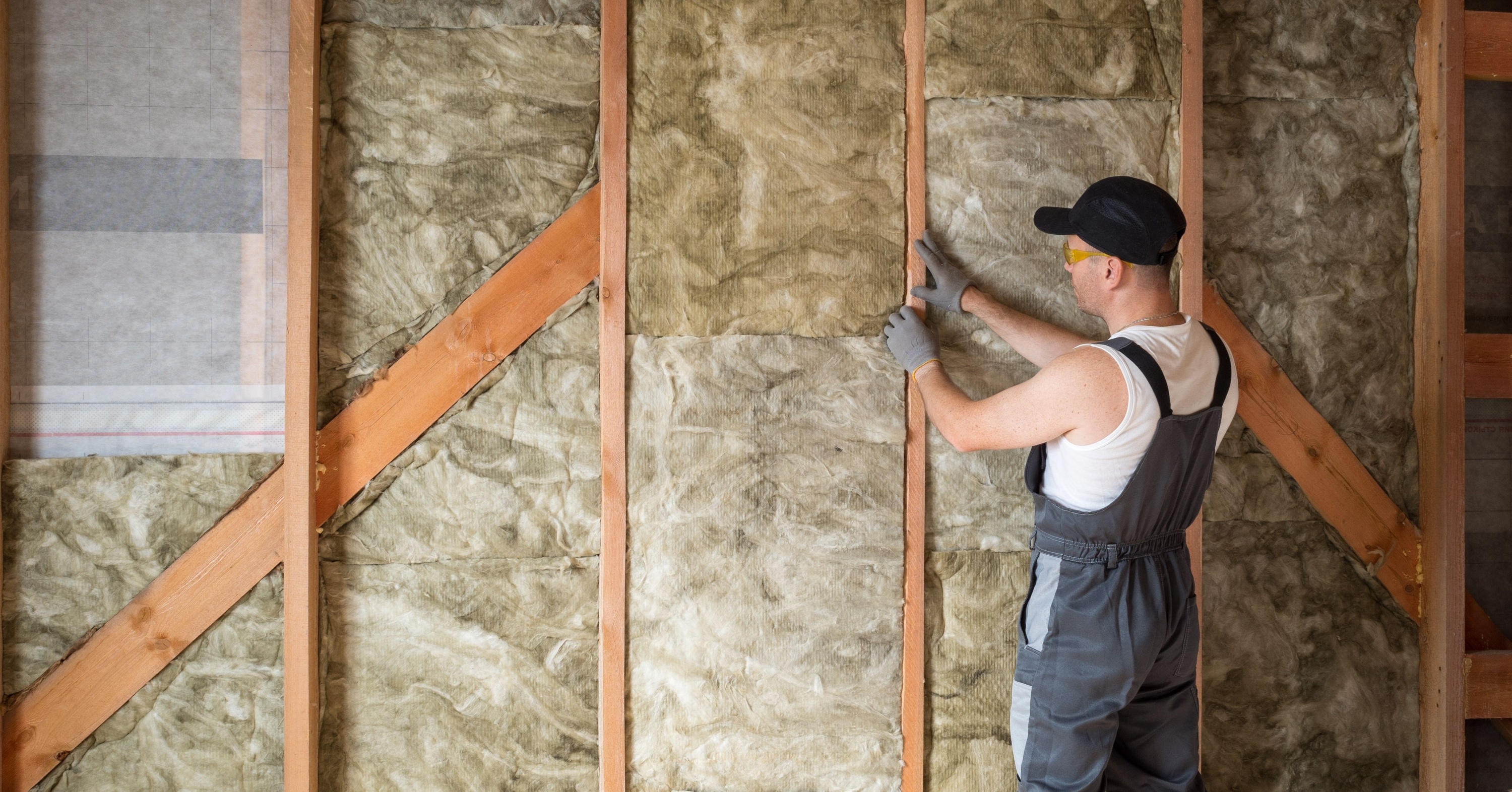 Professional insulating a wall.